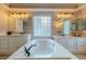 Bright bathroom featuring a large soaking tub, dual vanities, and neutral color palette at 10744 Balsam Creek Ave, Las Vegas, NV 89144