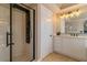 Bathroom featuring a glass enclosed shower with black trim, vanity, and travertine tile at 10744 Balsam Creek Ave, Las Vegas, NV 89144