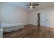 Bedroom featuring hardwood floors, ceiling fan with light, and closet with sliding doors at 10744 Balsam Creek Ave, Las Vegas, NV 89144