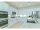 Well-appointed kitchen with stainless appliances, white cabinetry and large center island for entertaining at 10744 Balsam Creek Ave, Las Vegas, NV 89144