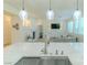 Beautiful kitchen with modern faucet overlooking the living room and fireplace at 10744 Balsam Creek Ave, Las Vegas, NV 89144