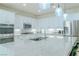 Modern kitchen with white cabinets, stainless steel appliances, and a large marble island at 10744 Balsam Creek Ave, Las Vegas, NV 89144
