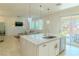 Modern kitchen island with pendant lighting and stainless steel appliances at 10744 Balsam Creek Ave, Las Vegas, NV 89144