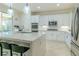 Bright modern kitchen with white cabinets, stainless appliances, and island seating at 10744 Balsam Creek Ave, Las Vegas, NV 89144