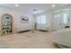Bright living room with tile floors, modern sofas, and custom built-in display cabinet at 10744 Balsam Creek Ave, Las Vegas, NV 89144