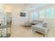 Stylish living room featuring a comfortable gray sofa, sleek TV, and elegant wall trim at 10744 Balsam Creek Ave, Las Vegas, NV 89144