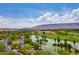 Scenic aerial view overlooking lush landscaping and a serene lake on the golf course at 11 Misty Peaks Ct, Las Vegas, NV 89135