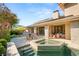 Outdoor seating area overlooking custom pool, spa, and lush landscaping at 11 Misty Peaks Ct, Las Vegas, NV 89135