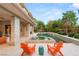 Outdoor living space with pool, spa, patio, and custom seating at 11 Misty Peaks Ct, Las Vegas, NV 89135