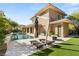 Beautiful backyard with a pool, lounge chairs, and lush landscaping at 11 Misty Peaks Ct, Las Vegas, NV 89135