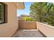 Tiled balcony offering peaceful views of mature trees and surrounding landscape at 11 Misty Peaks Ct, Las Vegas, NV 89135