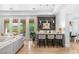 Open-concept bar area featuring a stylish bar, seating, and views of the outdoor pool at 11 Misty Peaks Ct, Las Vegas, NV 89135