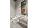 Stylish powder room featuring patterned wallpaper, unique lighting, and a modern vanity with mosaic tiled floors at 11 Misty Peaks Ct, Las Vegas, NV 89135