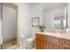 Bathroom featuring a wood cabinet vanity, a framed mirror, and a glass shower at 11 Misty Peaks Ct, Las Vegas, NV 89135
