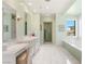 Elegant bathroom with dual vanity, shower, tub, and marble floors at 11 Misty Peaks Ct, Las Vegas, NV 89135