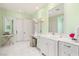 Bright bathroom featuring double vanity, makeup table, and ample counter space at 11 Misty Peaks Ct, Las Vegas, NV 89135