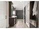 Bathroom boasts dual vanities, modern cabinets, a glass-enclosed shower, and sleek tile flooring at 11 Misty Peaks Ct, Las Vegas, NV 89135