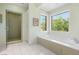 Bathroom with a large soaking tub and walk-in shower with mosaic tiling at 11 Misty Peaks Ct, Las Vegas, NV 89135