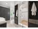 Bathroom featuring modern cabinets, a glass-enclosed shower, and sleek tile flooring at 11 Misty Peaks Ct, Las Vegas, NV 89135