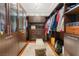 Spacious walk-in closet with custom wood cabinetry and ample hanging space at 11 Misty Peaks Ct, Las Vegas, NV 89135