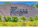 Stone entrance sign to The Ridges community with colorful flowers and greenery at 11 Misty Peaks Ct, Las Vegas, NV 89135