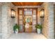 Elegant front door with stone surround, sidelights, and transom window, leading to a luxurious interior at 11 Misty Peaks Ct, Las Vegas, NV 89135