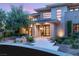 Modern home with stone accents, a well-manicured yard, and an elegant, covered entryway at 11 Misty Peaks Ct, Las Vegas, NV 89135
