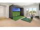 Game room with golf simulator and access to outdoor balcony at 11 Misty Peaks Ct, Las Vegas, NV 89135