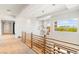 Upstairs hallway with modern railing system, neutral carpeting and plenty of natural light at 11 Misty Peaks Ct, Las Vegas, NV 89135