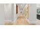 Bright hallway with hardwood floors and decorative artwork, leading to other rooms at 11 Misty Peaks Ct, Las Vegas, NV 89135