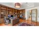 This is a home office with custom wood built-ins, hardwood floors, desk and office chair at 11 Misty Peaks Ct, Las Vegas, NV 89135