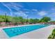 Community lap pool with clearly marked lanes and surrounding greenery at 11 Misty Peaks Ct, Las Vegas, NV 89135
