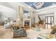 Comfortable living room featuring a stone fireplace, modern lighting, and stylish decor at 11 Misty Peaks Ct, Las Vegas, NV 89135