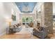 Cozy living room featuring a decorative fireplace, chandelier and French doors to the yard at 11 Misty Peaks Ct, Las Vegas, NV 89135