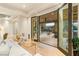 Living room with glass doors to backyard patio with outdoor kitchen and pool at 11 Misty Peaks Ct, Las Vegas, NV 89135