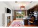 Home office with fireplace, TV, natural lighting and floor to ceiling bookcase at 11 Misty Peaks Ct, Las Vegas, NV 89135