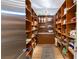 Organized pantry featuring custom wood shelving, ample storage space, and easy access to kitchen essentials at 11 Misty Peaks Ct, Las Vegas, NV 89135