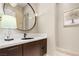 Elegant powder room featuring a unique round mirror and stylish lighting fixtures at 11 Misty Peaks Ct, Las Vegas, NV 89135