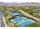 Aerial view of community tennis courts surrounded by lush landscaping and greenery at 11 Misty Peaks Ct, Las Vegas, NV 89135
