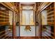 Elegant wine cellar with wood wine racks, glass doors, and temperature control for optimal storage at 11 Misty Peaks Ct, Las Vegas, NV 89135