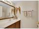 Bright bathroom featuring a vanity with granite counters and decorative mirror at 1101 Elation Ln # 2, Henderson, NV 89002