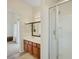 Well-lit bathroom featuring a shower, a vanity with storage, and tile flooring at 1101 Elation Ln # 2, Henderson, NV 89002