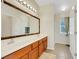 Bathroom with a double vanity, framed mirror, and access to a walk-in shower at 1101 Elation Ln # 2, Henderson, NV 89002