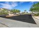 Community entrance with gated access, mature trees and landscaping, and clear signage for 'Paradise' at 1101 Elation Ln # 2, Henderson, NV 89002