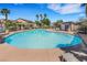 Large community pool area with lounge chairs and palm trees, perfect for relaxing and enjoying the outdoors at 1101 Elation Ln # 2, Henderson, NV 89002
