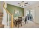 Light-filled dining area with wooden table set, sliding glass doors, and stairs leading upstairs at 1101 Elation Ln # 2, Henderson, NV 89002