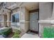 Inviting home entrance with decorative door, charming facade, and well-maintained landscaping at 1101 Elation Ln # 2, Henderson, NV 89002