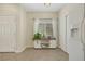 Inviting entryway featuring a white sideboard with decor, a window, and a tiled floor at 1101 Elation Ln # 2, Henderson, NV 89002