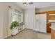 Bright entryway featuring white cabinets, a window with blinds, and tiled flooring at 1101 Elation Ln # 2, Henderson, NV 89002