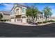 Multi-story townhome featuring a three-car garage, balcony, and nicely landscaped surroundings at 1101 Elation Ln # 2, Henderson, NV 89002